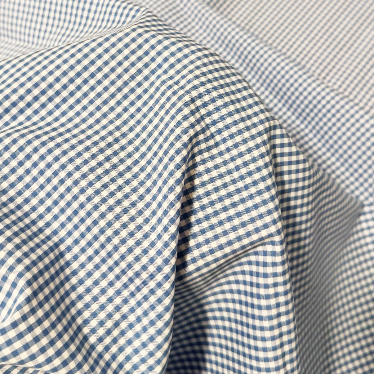 Close-up of blue and white mini gingham fabric.